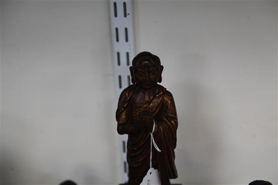 A Chinese gilt lacquered wood seated figure of Guandi, 18th / 19th century, and three other Chinese figures, all with some faults